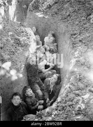 The children of hop pickers take shelter to watch the Battle of Britain . August 1940 . Stock Photo