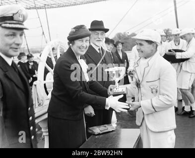 Prize Day on the HMS Worcester , the training ship of the Thames Nautical Training College in Greenhithe , Kent . A cadet is being presented with a trophy . 1939 Stock Photo