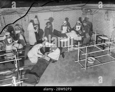 An emergency underground hospital in Erith , London . Nurses at work on the ' victims ' during a training drill . 1939 Stock Photo