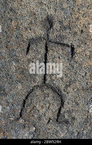 Art work of an early Hawaiian is preserved in this petroglyph found on the Big Island of Hawaii.  Drawing shows a man scratched in stone. Stock Photo
