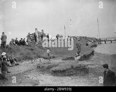 Crowds gather on the bank of the Thames estuary at Long Reach in Dartford , Kent , for a chance to spot the RMS Mauretania . RMS Mauretania is an ocean liner designed by Leonard Peskett and built by Swan , Hunter & Wigham Richardson at Wallsend , Tyne and Wear , for the British Cunard Line . 1939 Stock Photo