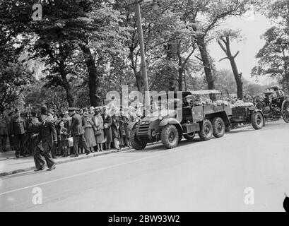 A military funeral procession in Woolwich , London . An armored vehicle tows a gun carriage onto which the coffin is placed . 23 May 1939 Stock Photo