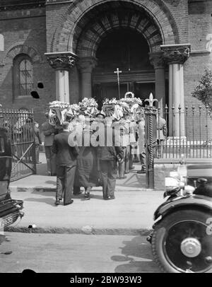 A military funeral procession in Woolwich , London . The pall bearers take the coffin into the church . 23 May 1939 Stock Photo