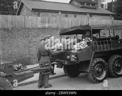 A military funeral procession in Woolwich , London . A floral spray on the back of an armored military vehicle . 23 May 1939 Stock Photo