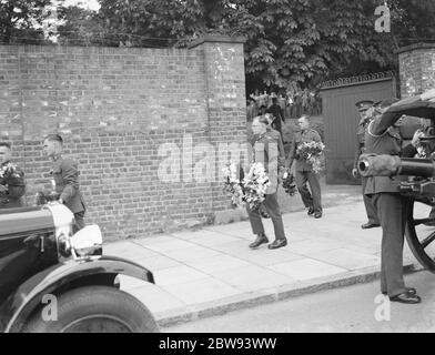 A military funeral procession in Woolwich , London . A floral spray is being carried by military personel . 23 May 1939 Stock Photo