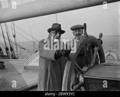 Old salts visit the Cutty Sark in Greenhithe , Kent . Commander J J W Calderon and Mr C Macdonald at the wheel . 1938 . Stock Photo