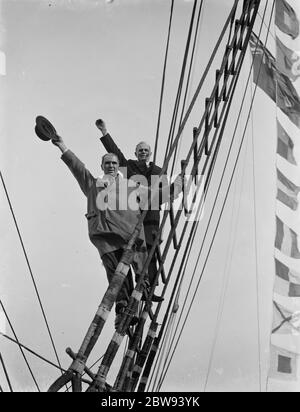 Old salts visit the Cutty Sark in Greenhithe , Kent . Captain R J Woodget and Captain A S Woodget wave from up the rigging . 1938 . Stock Photo