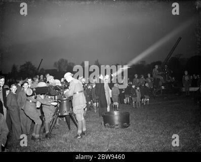 An anti aircraft display in Dartford , Kent . In the foreground personel operate a range finder whilst in the background a 3in gun crew gives a demonstration . 1938 Stock Photo