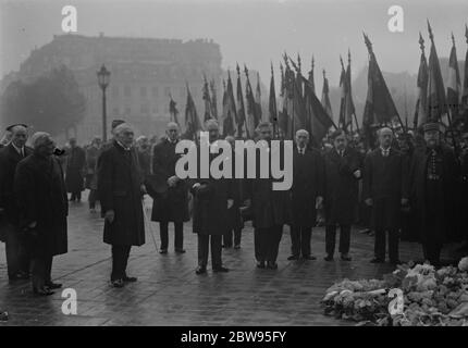 Armistice day celebrated in Paris . President Le Brun , of France , M Herriot , the Premier and members of the Cabinet attended the Armistice Day Remembrance service at the Tomb of the unknown warrior at the Arch de Triumph in Paris . President Le Brun and members of the French Cabinet at the Arch de Triumph in Paris at the service 11 November 1932 Stock Photo