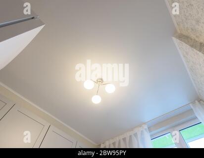 Stretch white matte ceiling in the interior of the kitchen Stock Photo