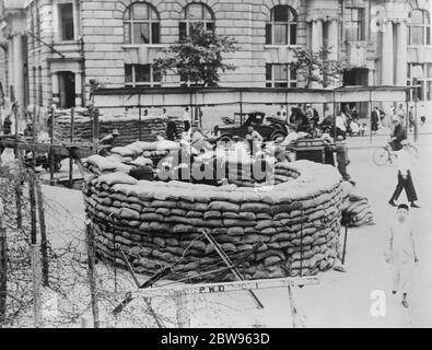 American sailors man sandbag barricades in Shanghai streets . A picture just recieved in London showing American sailors manning circular sandbag barricades at one of the entrances to the international settlement in Shanghai . Taken just before the situation assumed the serious aspect it now bears , prior to the actual declaration of war , it was yet thought neccessary by the American authorities to be prepared for any emergency call in the protection of their interests and those of the settlement . These sandbag fortresses were erected at every entrance to the settlement and manned by a handf Stock Photo