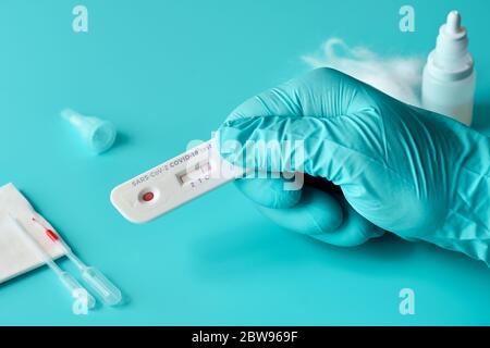 Express COVID-19 test for IgM and IgG antibodies to novel coronavirus SARS-CoV-2, Covid-19. Nurse or medtech hand in glove with positive coronavirus t Stock Photo