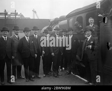 Station masters meeting in London to discuss their problems . Station masters from the London and North Eastern Railway stations all over England met at Liverpool Street station , London , for a conference to discuss their problems and establish personal contact between the stations . Among those present were station masters from Hull , Sunderland , Dundee , Manchester , Newcastle , Edinburgh , York , Glasgow , Marylebone and Kings Cross . Some of the station masters attending the conference chatting to an engine driver at Liverpool Street station , whose master Mr Hubert Calver may be seen ne Stock Photo