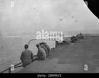 First Lord of the Admiralty Sir Bolton Eyres Monsell , left Portsmouth aboard the HMS Aircraft Carrier ' HMS Carageous ' and flew from the deck of the ship . He was present at the aerial training exercises of pilots attached to the aircraft carrier . Sir Bolton is the first ' First Lord ' to make a flight from an aircraft carrier . Blackburn Dart torpedo carrying plane returning to HMS Courageous after circling over the destroyers HMS Sesame and HMS Whirlwind . 26 April 1932 . Stock Photo