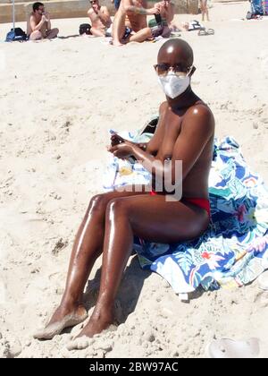 May 30, 2020, New York, New York, USA: Hot Weather today in N.Y.C. Sunbathers head to the clothes optional beach in Queens N.Y. some wearing masks and social distancing while other did not.  5/29/2020 (Credit Image: © Bruce Cotler/ZUMA Wire) Stock Photo