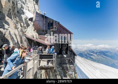 Chamonix-Mont-Blanc, France - August 03, 2019: A group of people enjoying beautifull view of Mont-Blanc massif from Aiguille du Midi Stock Photo