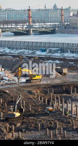 Top view of construction site with reinforced concrete piles and workers, excavators, vertical. Work on the preparation of the foundation of the build Stock Photo