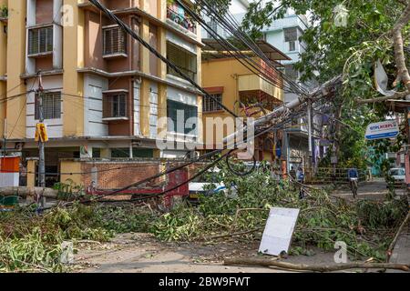 High tension electric wires hanging dangerously from a broken pole on a city road after cyclonic storm 'Amphan' struck landfall at Kolkata, India Stock Photo