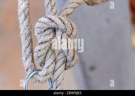nautical knots made of rough natural rope isolated on blurred background Stock Photo