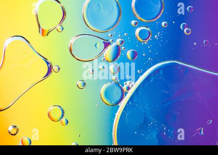 Beautiful and fantastic macro photo of water droplets in oil with a colorful background. Stock Photo