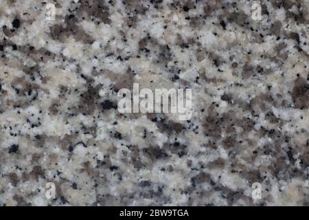 Grey beige and black mottled granite background with copy space Stock Photo