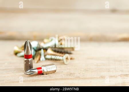 Two bits on the background of screws Stock Photo
