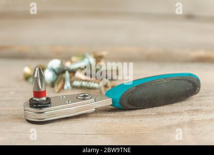 Ratchet with bats close-up on a wooden background. Stock Photo