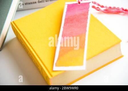 colorful bookmark on a closed yellow book. education. reading. Stock Photo