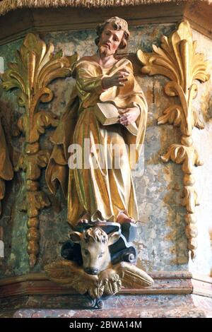 St. Luke the Evangelist statue at the pulpit in the Church of the Assumption of the Virgin Mary in Taborsko, Croatia Stock Photo