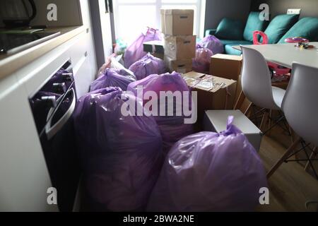 Kitchen is full garbage bags and cardboard boxes Stock Photo