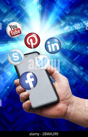 hand holding a smartphone with major social media apps logo Stock Photo