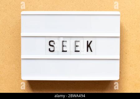 Lightbox with word seek on wood background Stock Photo