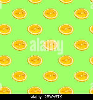 Seamless pattern with lemon slices on a salad background. Minimal isometric texture of food. Use for boards, print on fabric. View from above. Stock Photo