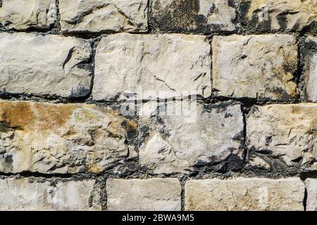 a cracked real stone wall surface Kendal Stock Photo