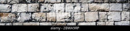 panorama of a cracked real stone wall surface Kendal Stock Photo