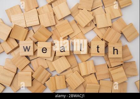 Wooden letter tiles spelling the word WEALTH Stock Photo