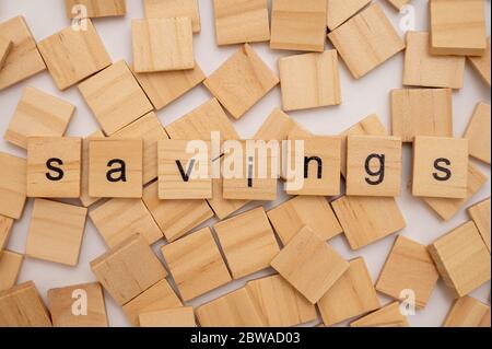 Wooden letter tiles spelling the word SAVINGS Stock Photo
