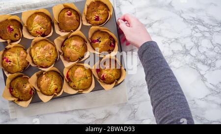 Flat lay. Step by step. Cooling freshly baked cranberry muffins. Stock Photo