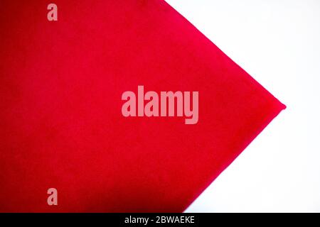 Close-up of red color velvet texture on a white background. Top view. Stock Photo