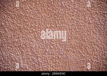 Rough wall stucco texture. Facade relief painted salmon. Stock Photo