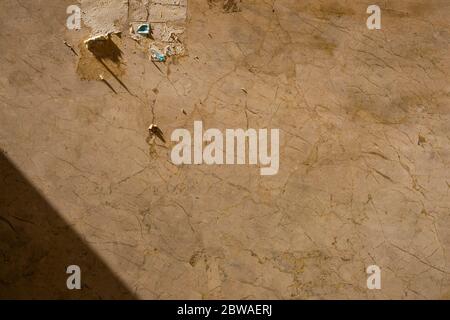 Dirty brown marble background texture with a torn out sign and shadow in a corner Stock Photo