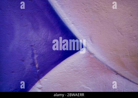 Purple and white colorful wall. Close-up of a graffiti texture. Street art background. Stock Photo