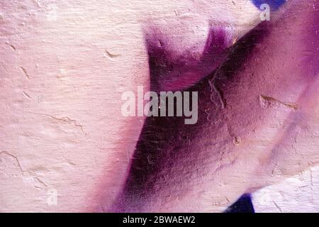 Purple dark abstract paint on a white wall. Close-up of a graffiti texture. Street art background. Stock Photo