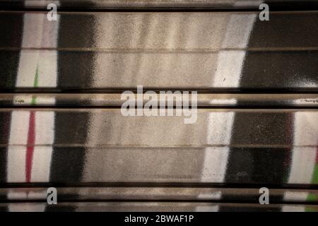 Metal garage door texture with graffiti close-up Stock Photo