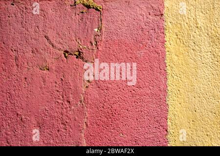 Red and yellow rough stucco wall texture cracked Stock Photo