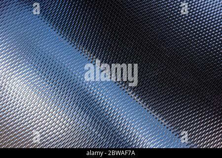 Metal pattern texture. Curved steel surface with reflection. Stock Photo