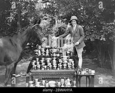 Little Miss Pauline Jones , of East Grinstead , who has already this season had 20 wins at various shows . seen here with some of her trophies of which she has over hundread 13 March 1932 Stock Photo