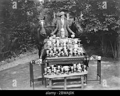 Little Miss Pauline Jones , of East Grinstead , who has already this season had 20 wins at various shows . seen here with some of her trophies of which she has over hundread 13 March 1932 Stock Photo