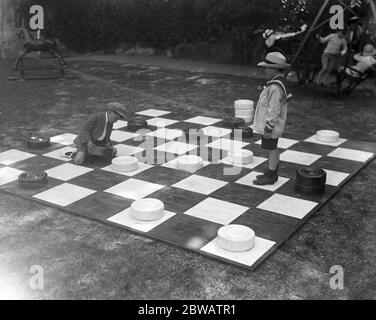 Children play giant draughts in Devonshire Park , Eastbourne , Sussex . 21 June 1920 Stock Photo