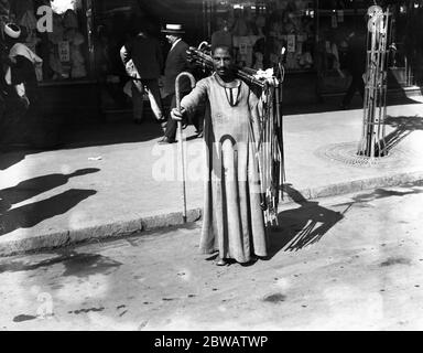 A man selling walking sticks on the streets of Cairo , Egypt . 21 March 1923 Stock Photo